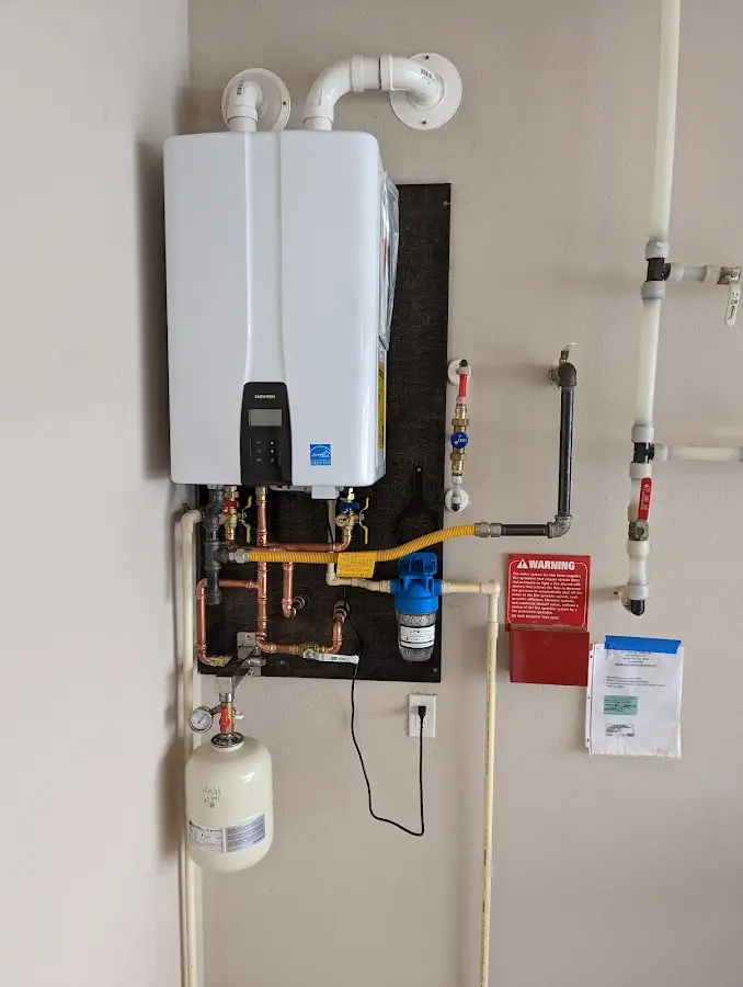 Professional plumber installing copper piping in a Olympia Heights home